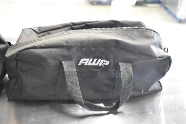 Black AWP tool bag with handles, zipper closure, containing DTE FS-100 DVCPro, showing wear.