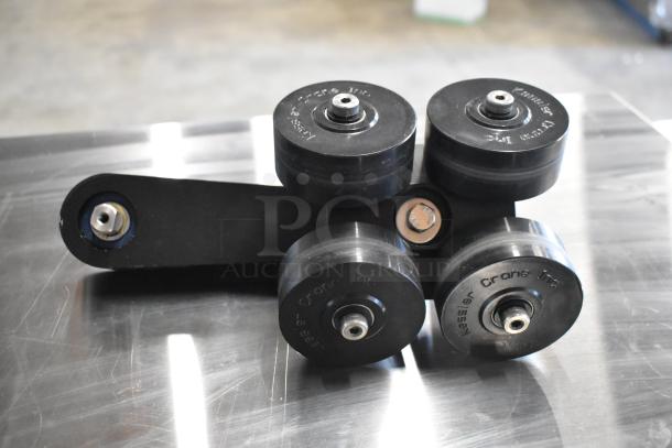 Kessler Crane Inc. dolly wheel set, black, with four rubber wheels on a metal bracket, gently used condition.