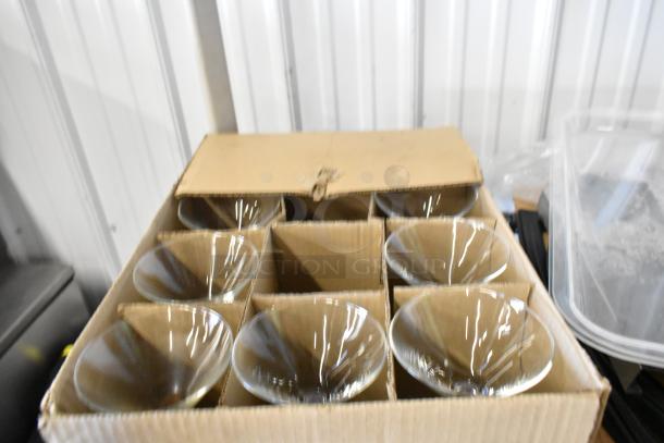Boxed set of flared coupe glassware, as part of a tier lot. New condition. Perfect for cocktails or champagne.