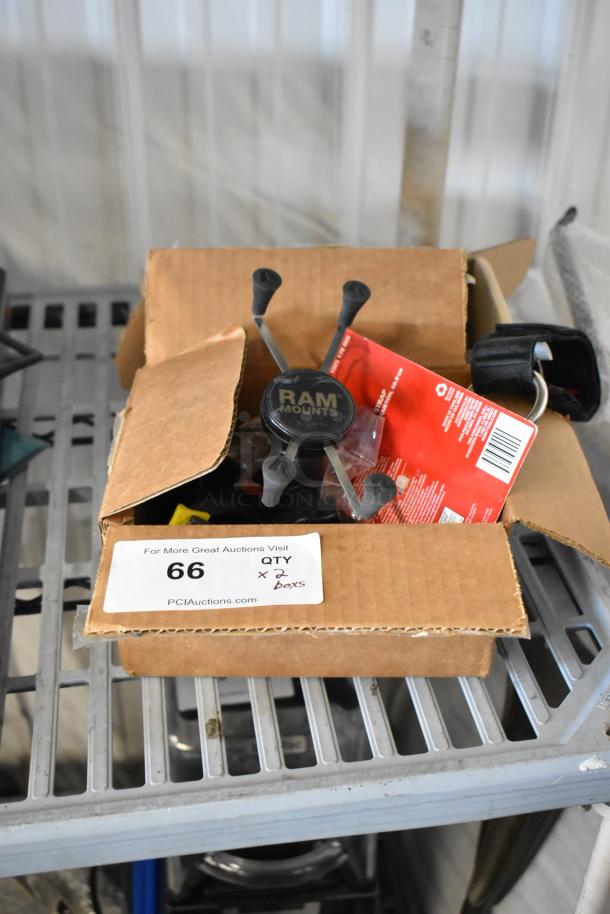 Two boxes containing Z Finder Pro Kit and clamps, featuring RAM Mounts. Includes auction label "66 QTY x 2 boxes."