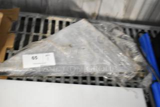 Stack of metal brackets wrapped in plastic, labeled with "65" and "QTY 11." They appear unused and in good condition.