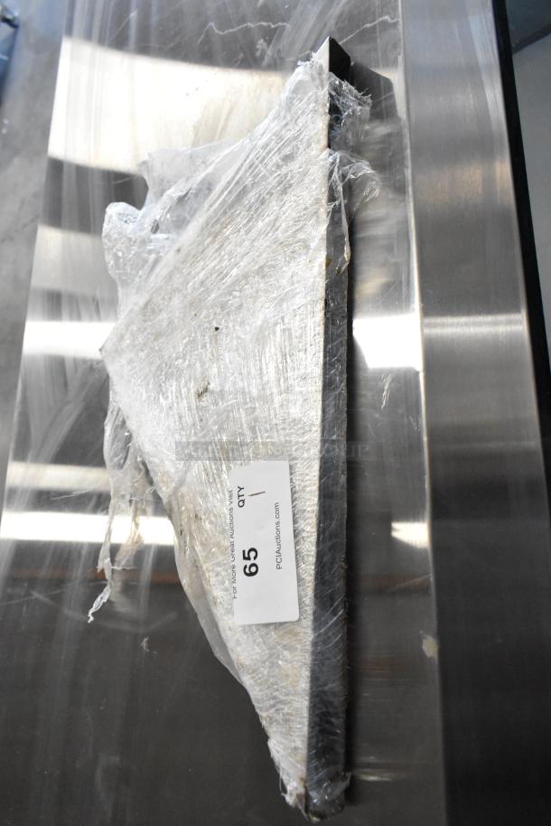 Metal brackets wrapped in plastic, with auction label tag number 65, showing PCAauctions.com.
