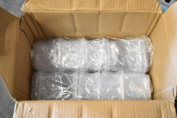Box of brand new Skroam food storage containers, packed in plastic wrapping, inside an open cardboard box.
