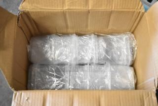Box of brand new Skroam food storage containers, packed in plastic wrapping, inside an open cardboard box.