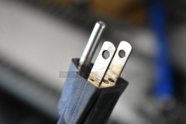 Blendtec blender power plug close-up, showing a standard three-prong configuration for 120 volts usage.