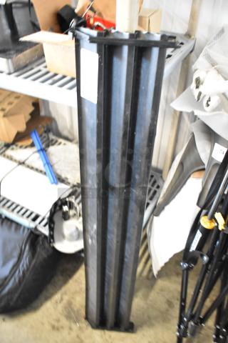 Black reach-in cooler vent cover, vertical, ridged design, in used condition. Label visible with unreadable text.