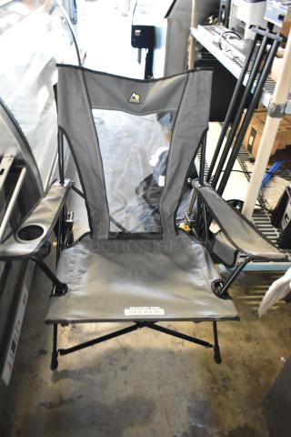 GCI Outdoor gray collapsible chair, includes armrests and cupholder, in good condition with "Comfort Pro Rocker" label.