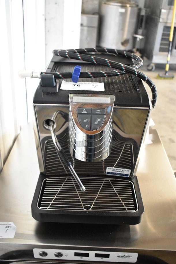 BRAND NEW SCRATCH AND DENT metal commercial countertop espresso machine with steam wand, visible power cord, and control panel.