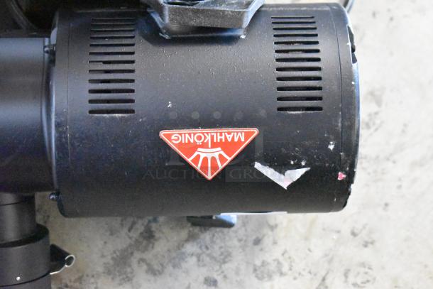 Brand new Mahlkonig EK43 3.3 lb. black coffee grinder with visible scratches and dents. 120 volts, 1 phase.