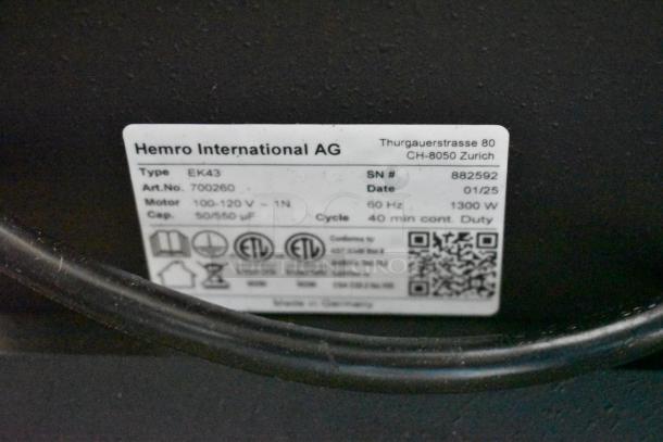 Label on 2025 Mahlkonig EK43 coffee grinder shows serial number 882592 and specs. Black, 3.3 lb, 120V, scratch and dent.