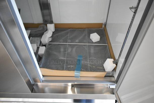 Brand new Avantco 178A49RHC stainless steel commercial cooler interior view, packaging intact, showing poly-coated racks and casters.