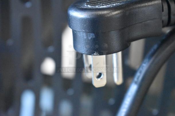 Close-up view of a black power plug for Avantco 178A49RHC stainless steel commercial cooler, showing its prongs.