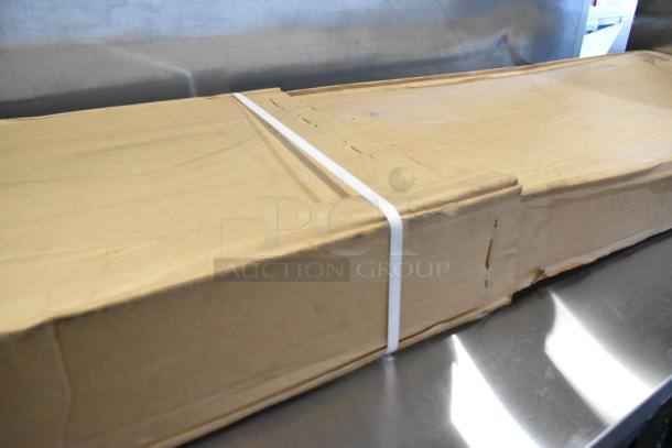 Cardboard box containing a Carlisle 926007 aluminum sneeze guard, 60" x 12.5", for buffet bars. Box shows some wear.