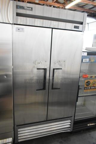 2017 True T-35-HC stainless steel 2-door reach-in cooler, poly-coated racks, on commercial casters. 115V, 1 phase.