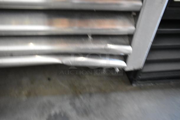 2017 True T-35-HC stainless steel 2-door reach-in cooler with poly-coated racks on commercial casters. Some visible denting.