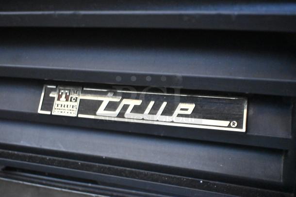 True GDM-12 metal commercial cooler, single door, poly-coated racks, 115V, 1 phase. True logo displayed.