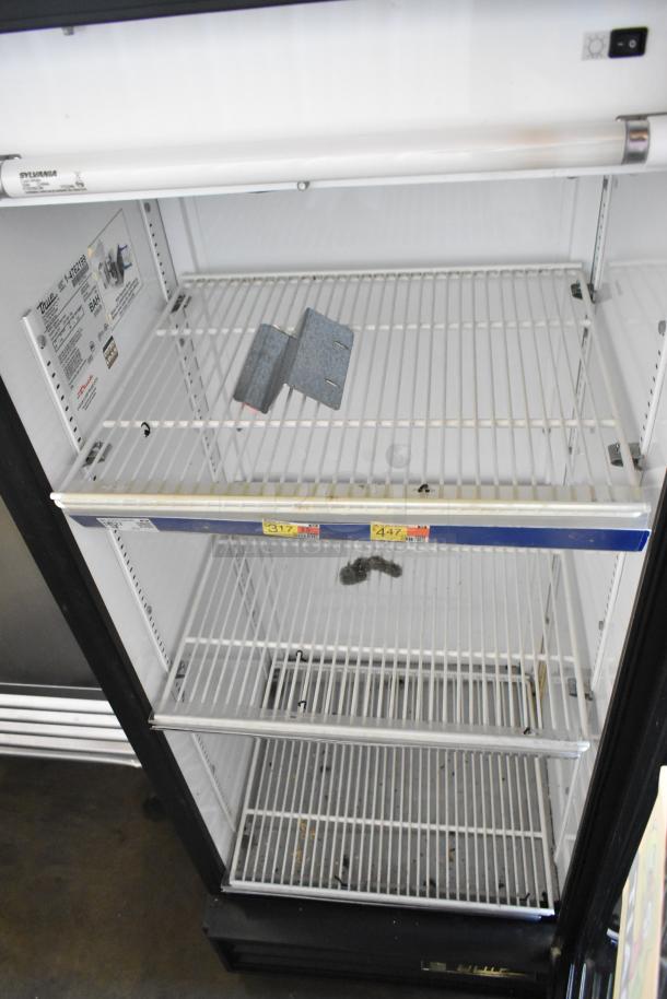 True GDM-12 metal cooler merchandiser, single door, poly-coated racks, 115 volts, 1 phase, visible interior tags.