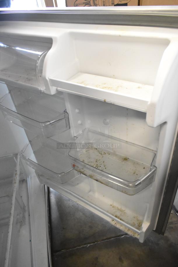 2022 Whirlpool WRT311FZDM05 stainless steel cooler with freezer, interior showing shelves, some dirt is visible, 115V, 1 phase.