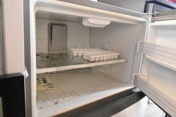 2016 Whirlpool WRT511SZDM00 stainless steel cooler with freezer, visible wear, 115 volts, 1 phase. Interior shows marks and ice trays.