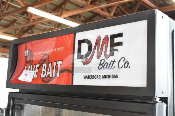 2019 True GDM-26-HC single door cooler merchandiser, featuring poly-coated racks. Branded with DMF Bait Co., Waterford, MI. Model shows commercial use. 115 Volts, 1 Phase.