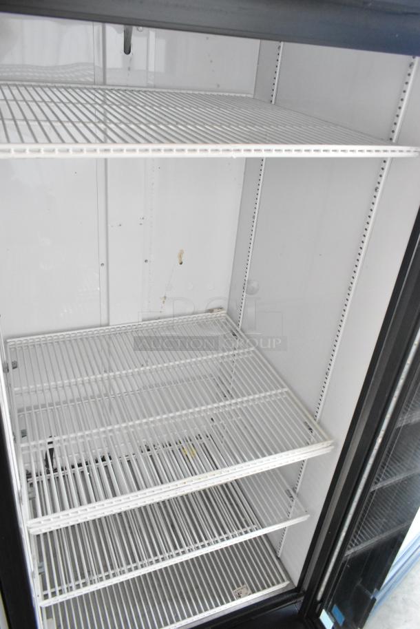 2019 True GDM-26-HC commercial cooler, single glass door, poly coated racks, 115V, used, clean interior, minor wear.