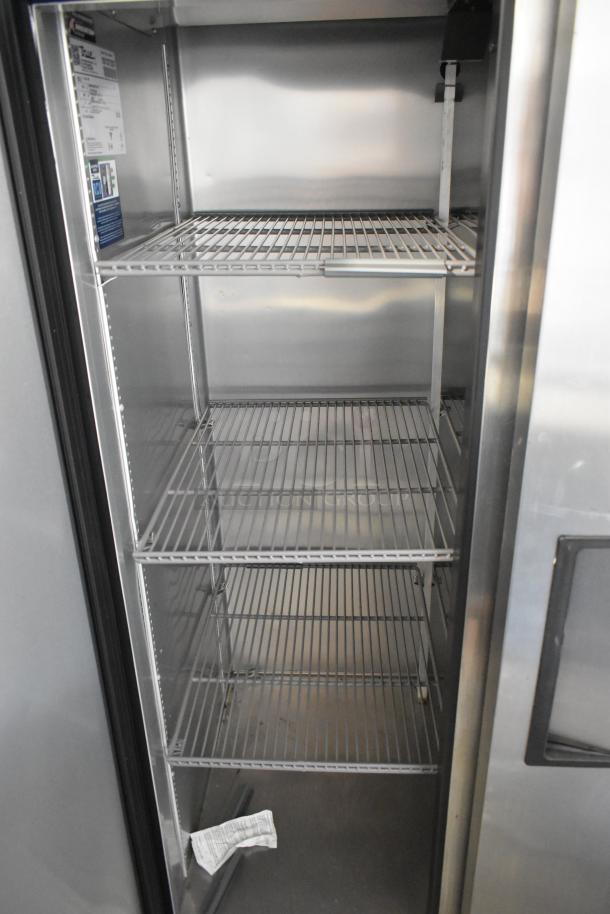 True stainless steel commercial 2 door reach-in cooler with poly-coated racks, 115 volts, 1 phase, interior view.
