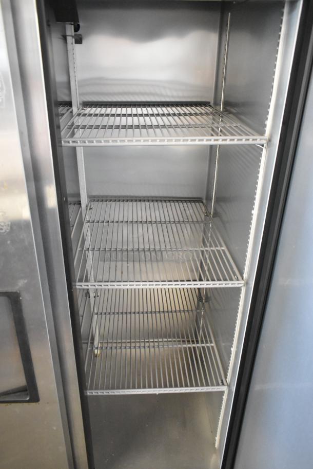 True Stainless Steel Commercial 2 Door Reach In Cooler with poly coated racks, 115 volts, 1 phase, interior view.