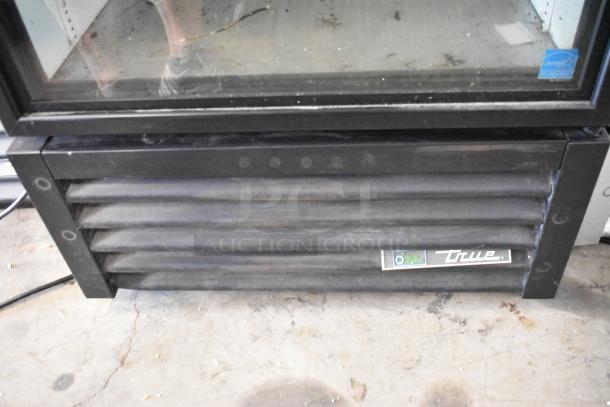 2020 True GDM-26-HC single door cooler merchandiser with poly-coated racks, 115V, True logo visible, fair condition.