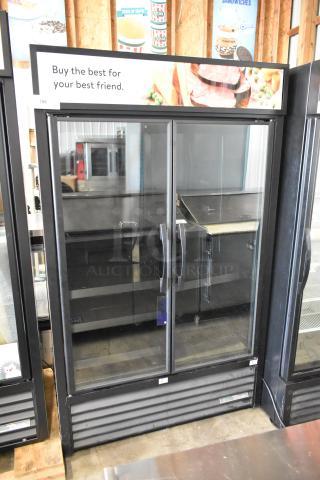 True Metal Commercial 2 Door Reach-In Cooler with metal shelves, 115V, 1 phase. Features glass doors and promo signage.