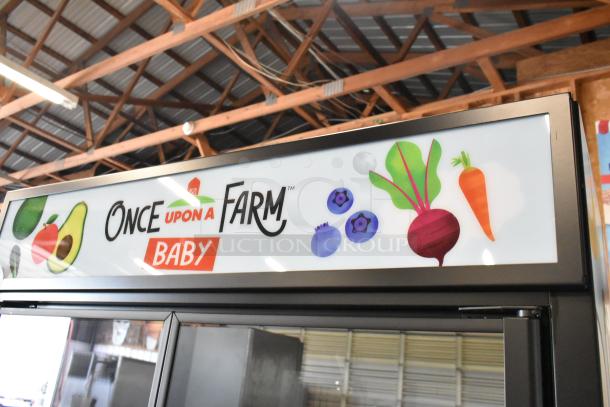 2025 True TVM-48SL-HC 2 Door Cooler Merchandiser with metal shelves, "Once Upon a Farm Baby" branding, 115 volts, 1 phase.