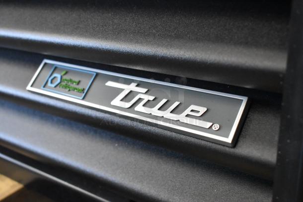 True TVM-48SL-HC reach-in cooler label, showcasing brand logo and energy star certification.