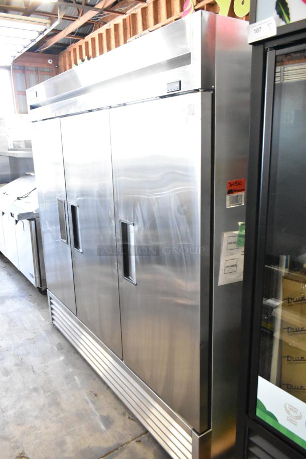 2022 True T-72-HC stainless steel commercial 3-door reach-in cooler with poly coated racks, 115 volts, 1 phase.
