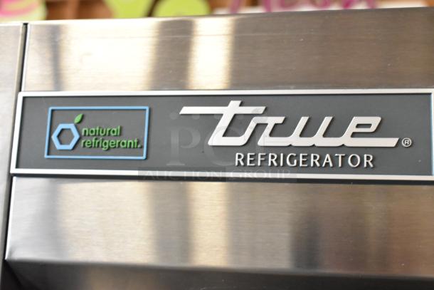 2022 True T-72-HC stainless steel 3-door commercial cooler, features natural refrigerant label, 115V, 1 phase.