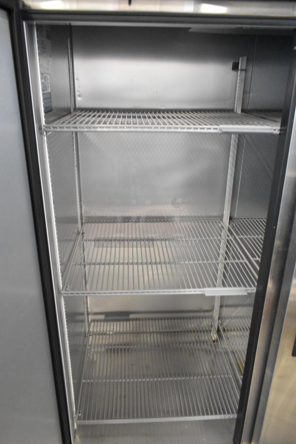 2022 True T-72-HC stainless steel commercial 3-door reach-in cooler with poly-coated racks, 115 volts, 1 phase.