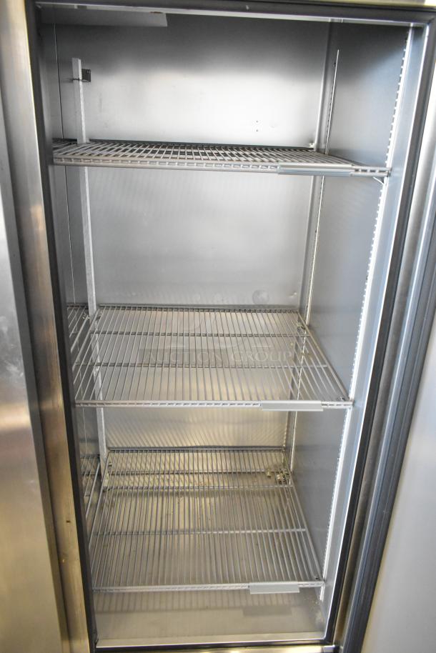 2022 True T-72-HC stainless steel 3-door reach-in cooler with poly-coated racks, 115 volts, excellent condition.