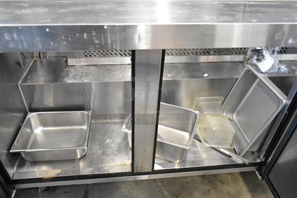 2018 Atosa MSF8308GR stainless steel prep table, showing internal storage area with metal trays, on commercial casters.