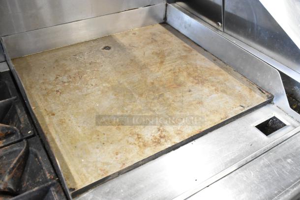 Black Diamond GR-6024G/NG 6 burner range with flat top griddle, stainless steel, visible wear, on casters.
