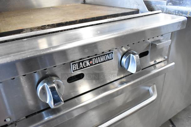 Black Diamond GR-6024G/NG 6 burner range with griddle, 2 ovens, over shelf, stainless steel, 280,000 BTU, on casters.