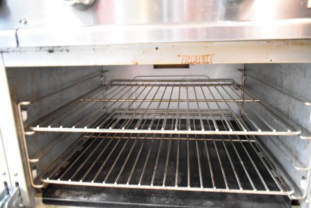 Black Diamond GR-6024G/NG oven interior with two wire racks. Stainless steel commercial range, 280,000 BTU capacity.