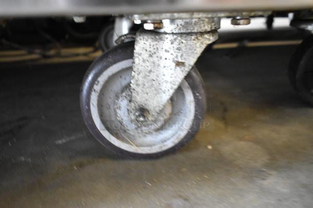 Stainless steel commercial caster wheel for Black Diamond GR-6024G/NG range; used, with visible wear and markings.