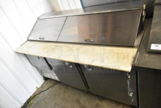 Hudson stainless steel sandwich salad prep table, mega top, bain marie on casters. Features include dual sliding doors and sturdy construction. Runs on 115 volts, 1 phase. Visible wear on surface.