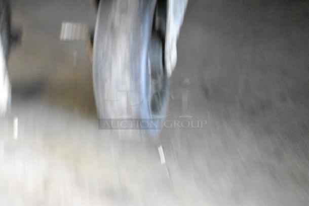 Blurry image of a wheel, possibly from the Atosa MSF8308GR prep table, showing motion or an out-of-focus view.