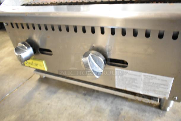 Qualite QLEC-24/NG commercial stainless steel charbroiler grill, natural gas, 60,000 BTU, dual knobs, visible labels.