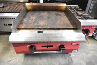 2024 Avantco 177CAG24MG stainless steel commercial flat top griddle, natural gas powered, lightly worn surface, dual controls.