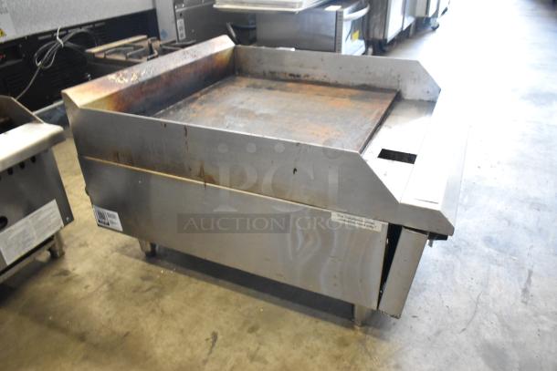 2024 Avantco 177CAG24MG stainless steel natural gas flat top griddle, worn condition, ventilation label visible.
