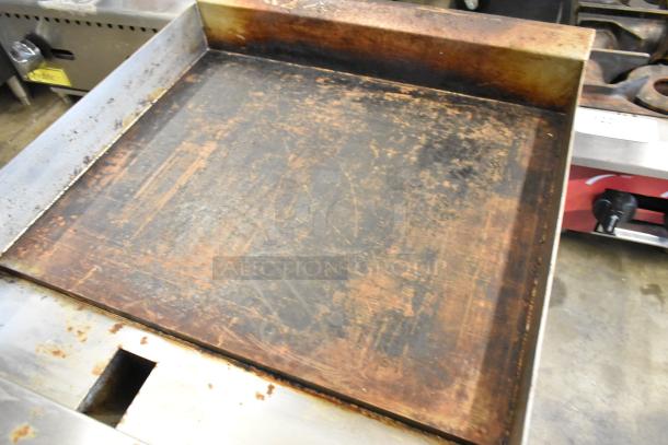 2024 Avantco 177CAG24MG stainless steel countertop griddle, natural gas powered, signs of heavy use, flat cooking surface.