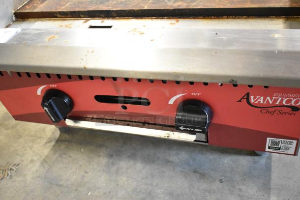 2024 Avantco 177CAG24MG stainless steel natural gas griddle. Features dual control knobs, visible wear on surface.