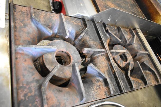 2023 Avantco 177CAGR212 stainless steel commercial countertop 2 burner range with visible wear, natural gas powered.