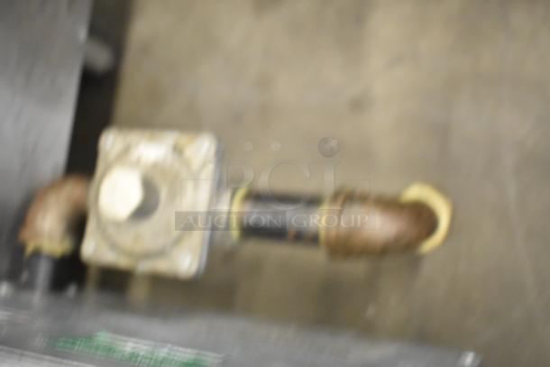 Blurry image, possibly showing part of the Avantco 177CAGR212 gas range connection. Details unclear.