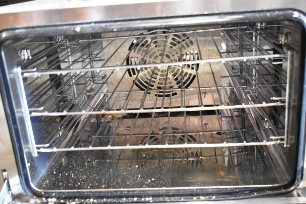 Avantco 177CO14 stainless steel convection oven interior with shelves, visible signs of use, 120V single phase.
